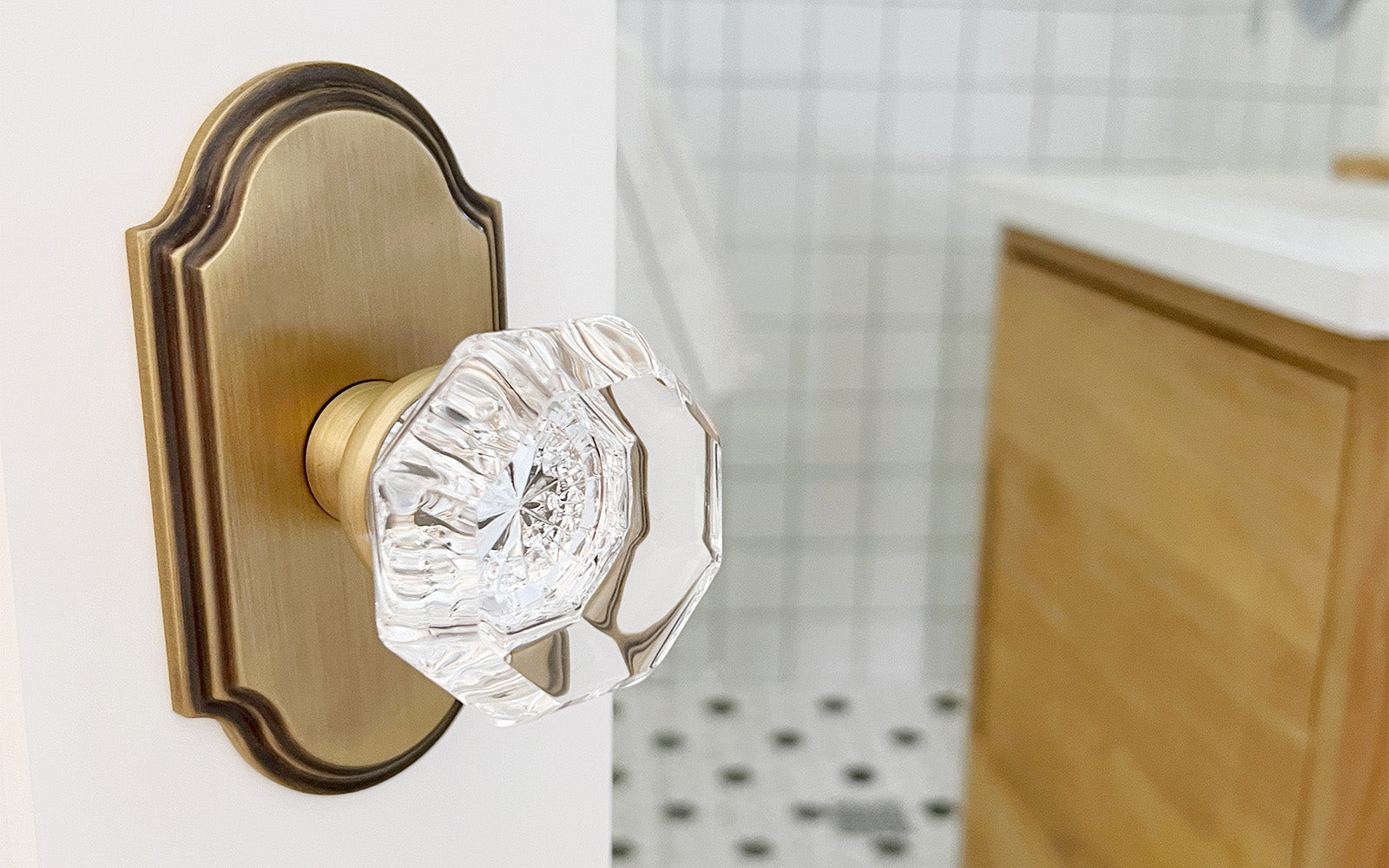 bathroom remodel with luxury door hardware in vintage brass finish with crystal doorknob grandeur hardware