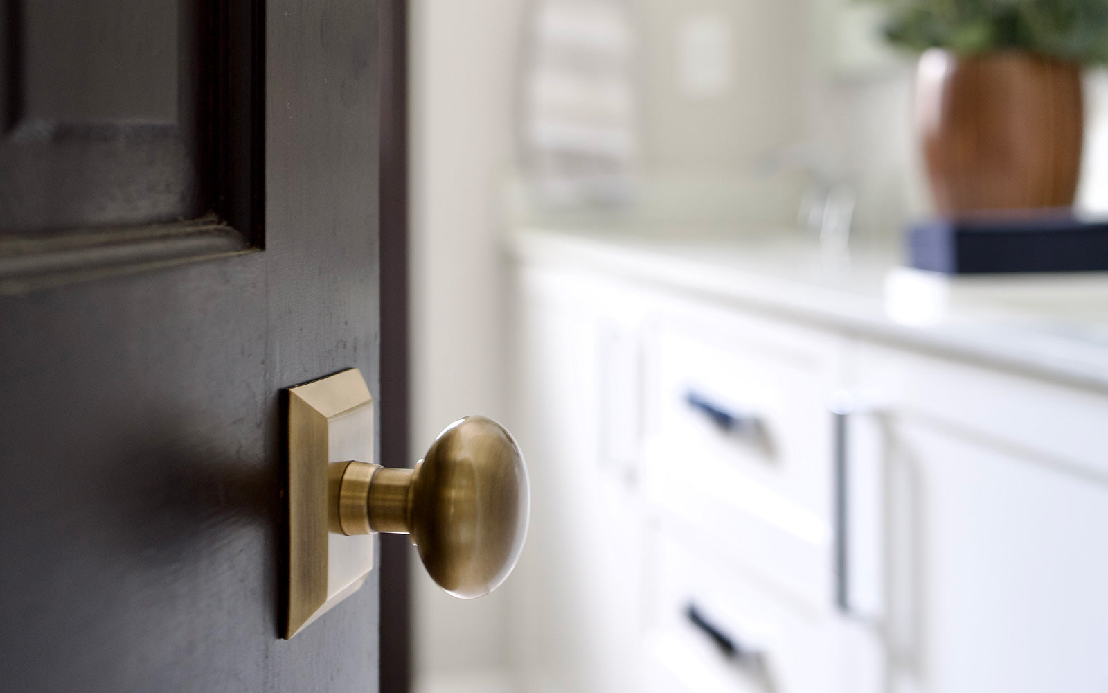 black bathroom door with vintage brass square door hardware from grandeur luxury