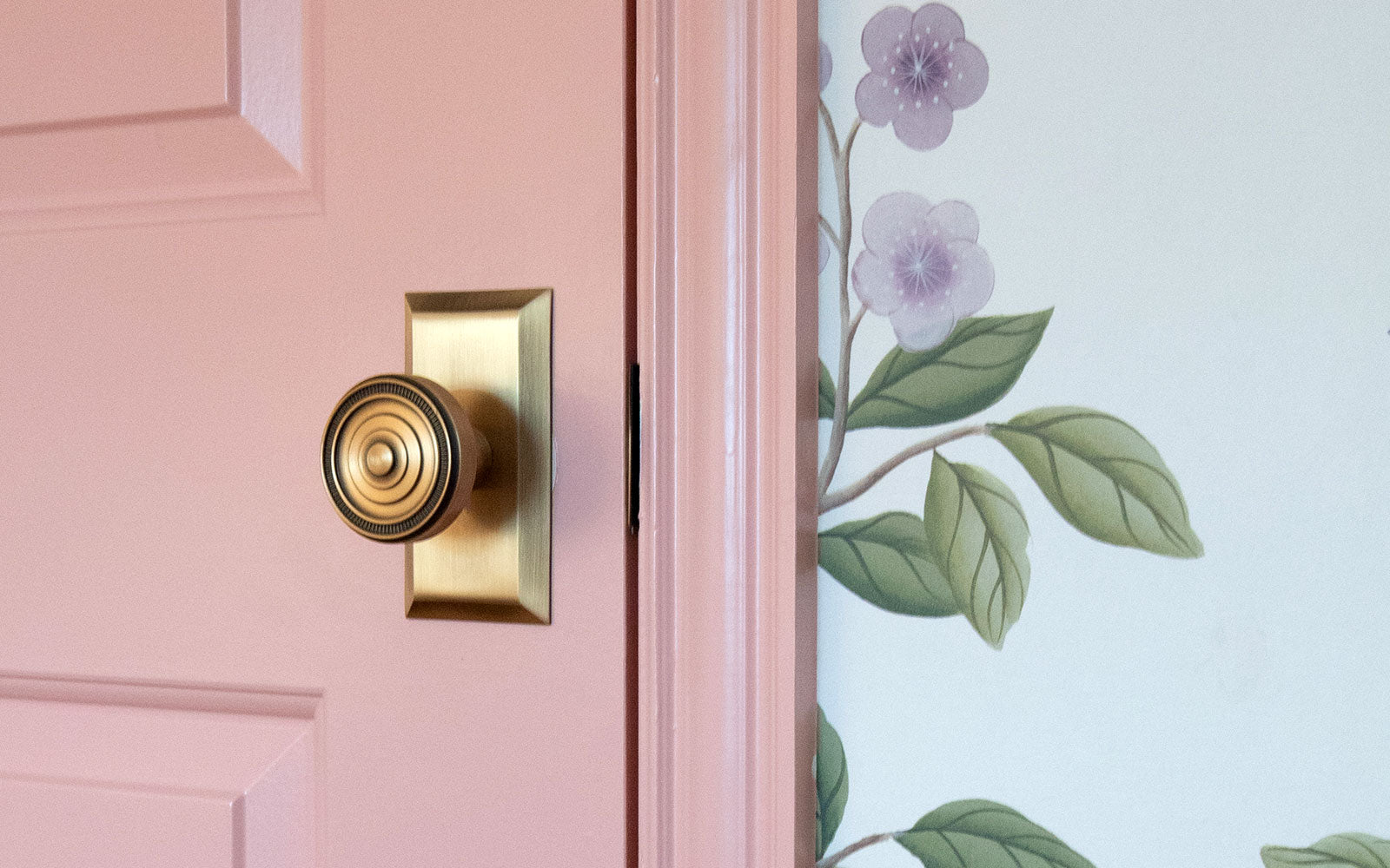 pink door floral wallpaper girls bedroom vintage brass door hardware grandeur luxury home